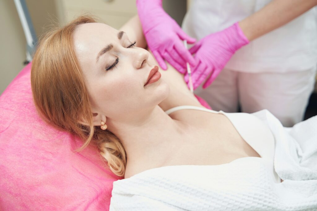 Female during the procedure of botulinum toxin against hyperhidrosis in clinic
