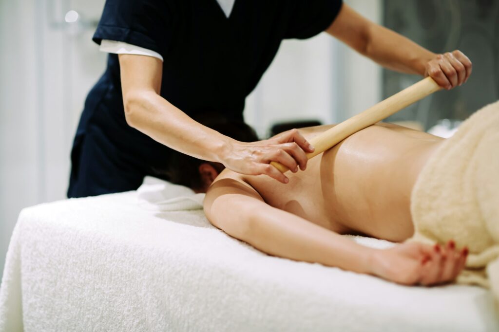 Masseur treating patient with therapeutic massage