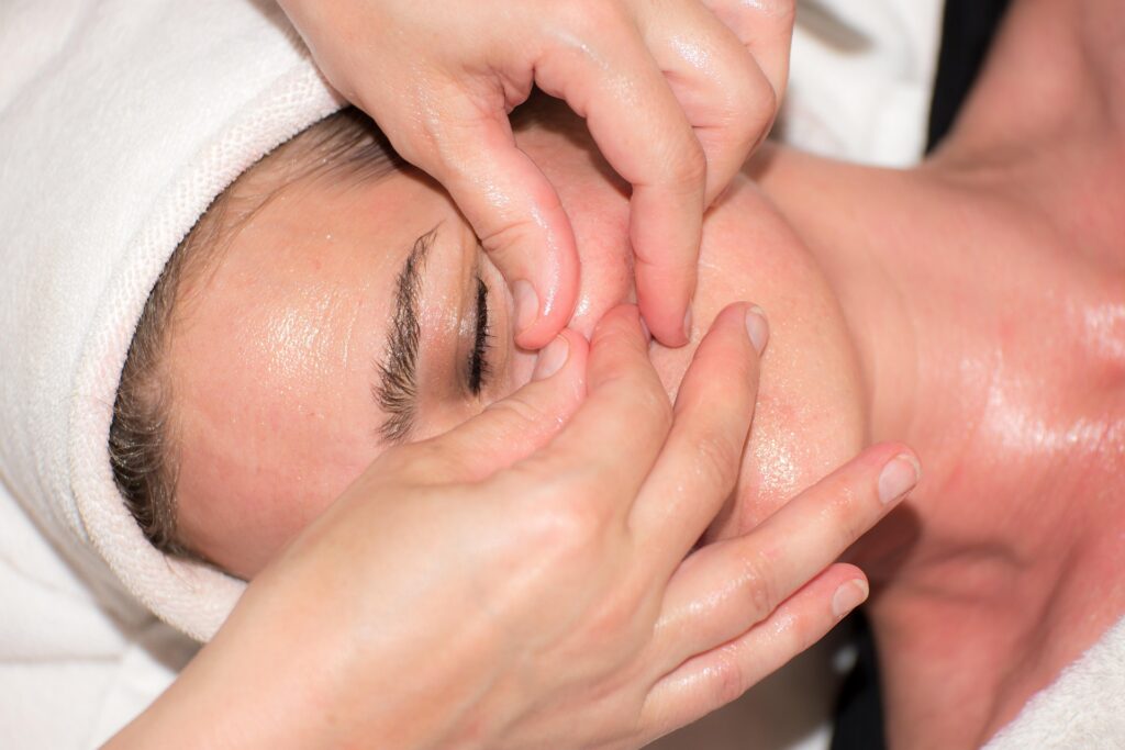 Professional esthetician performing a facial massage to improve circulation and promote healthy, glowing skin.