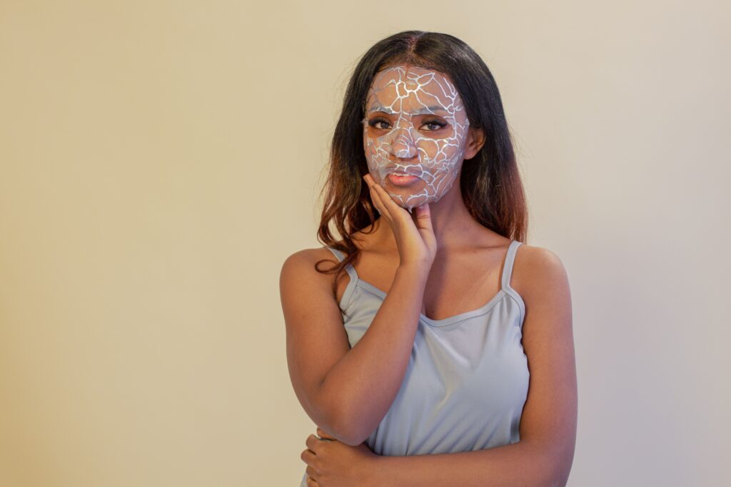 Woman with a facial treatment mask demonstrating a professional skincare treatment for improving skin texture and hydration.