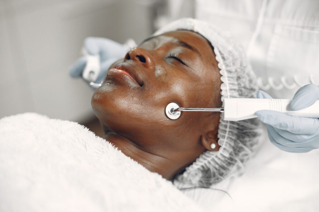 Patient receiving a high-frequency facial treatment designed to improve skin tone, texture, and overall complexion.