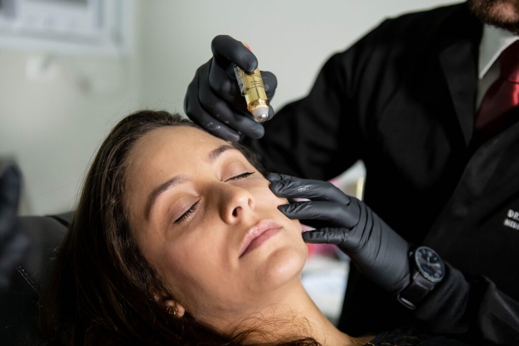 Medical professional performing a microneedling treatment to improve skin texture and stimulate collagen production.