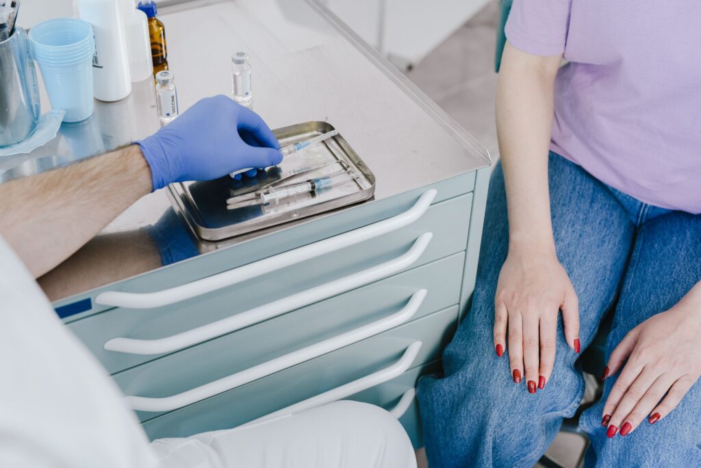 Medical professional preparing injectable treatment syringes before a cosmetic procedure in a medical spa.